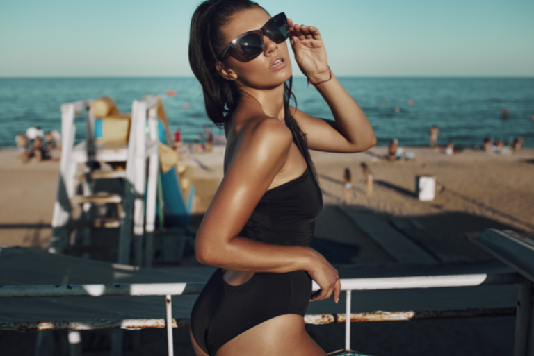 Tanned woman at the beach - Why am I not getting a tan?