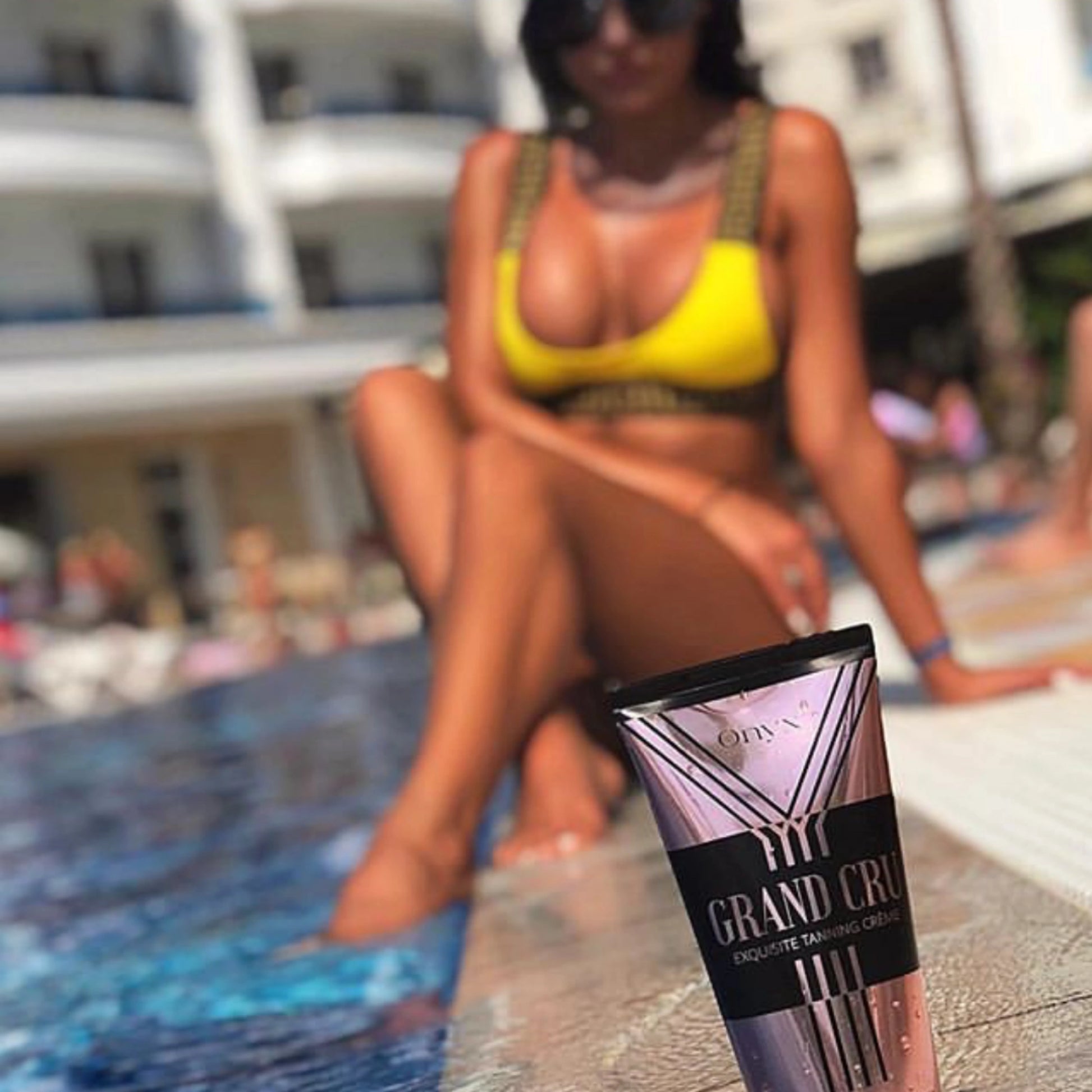 Onyx Grand Cru tanning lotion by the poolside, ideal for achieving a natural sun-kissed glow.