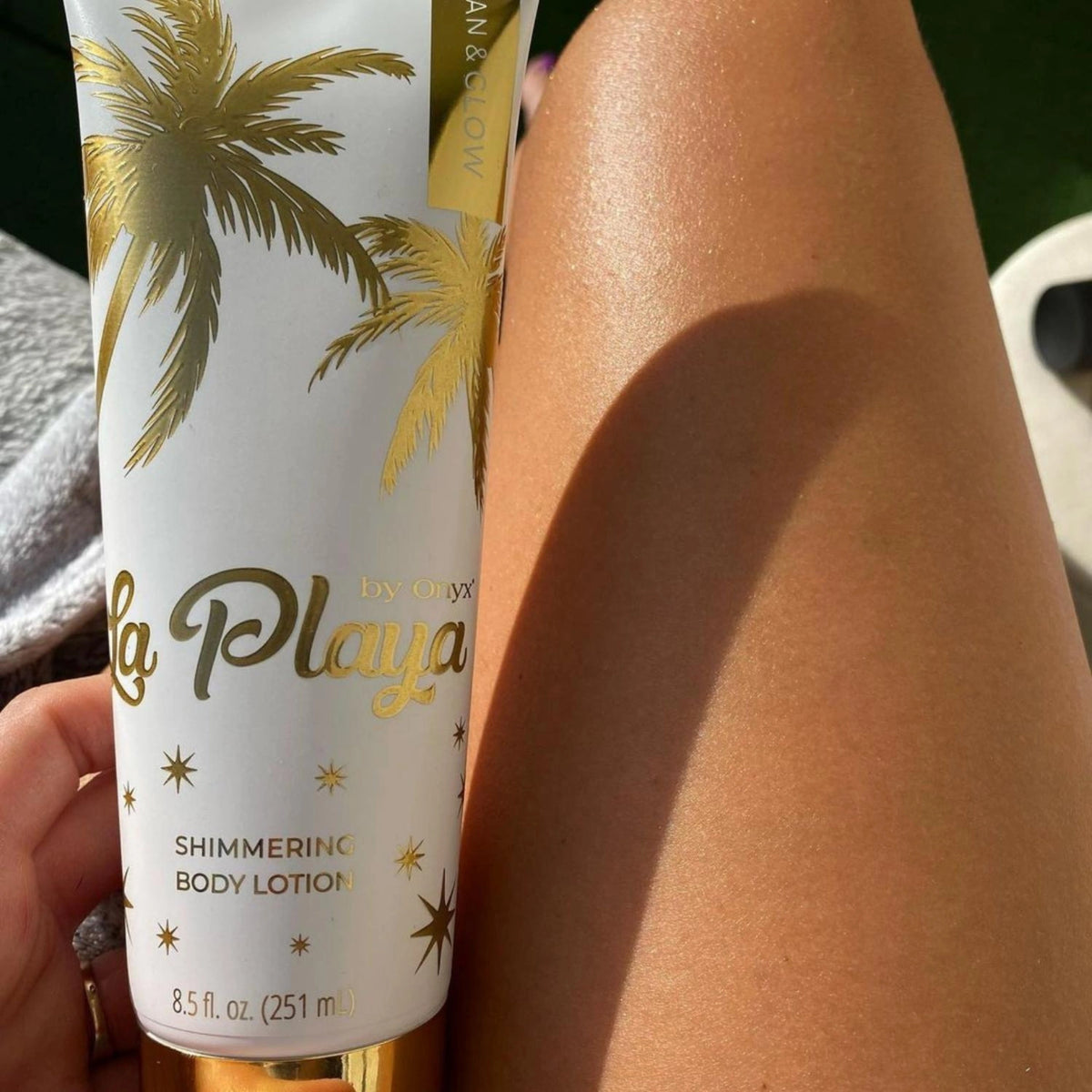 Sunlit legs glowing with Onyx La Playa shimmering body lotion, perfect for radiant, hydrated skin.