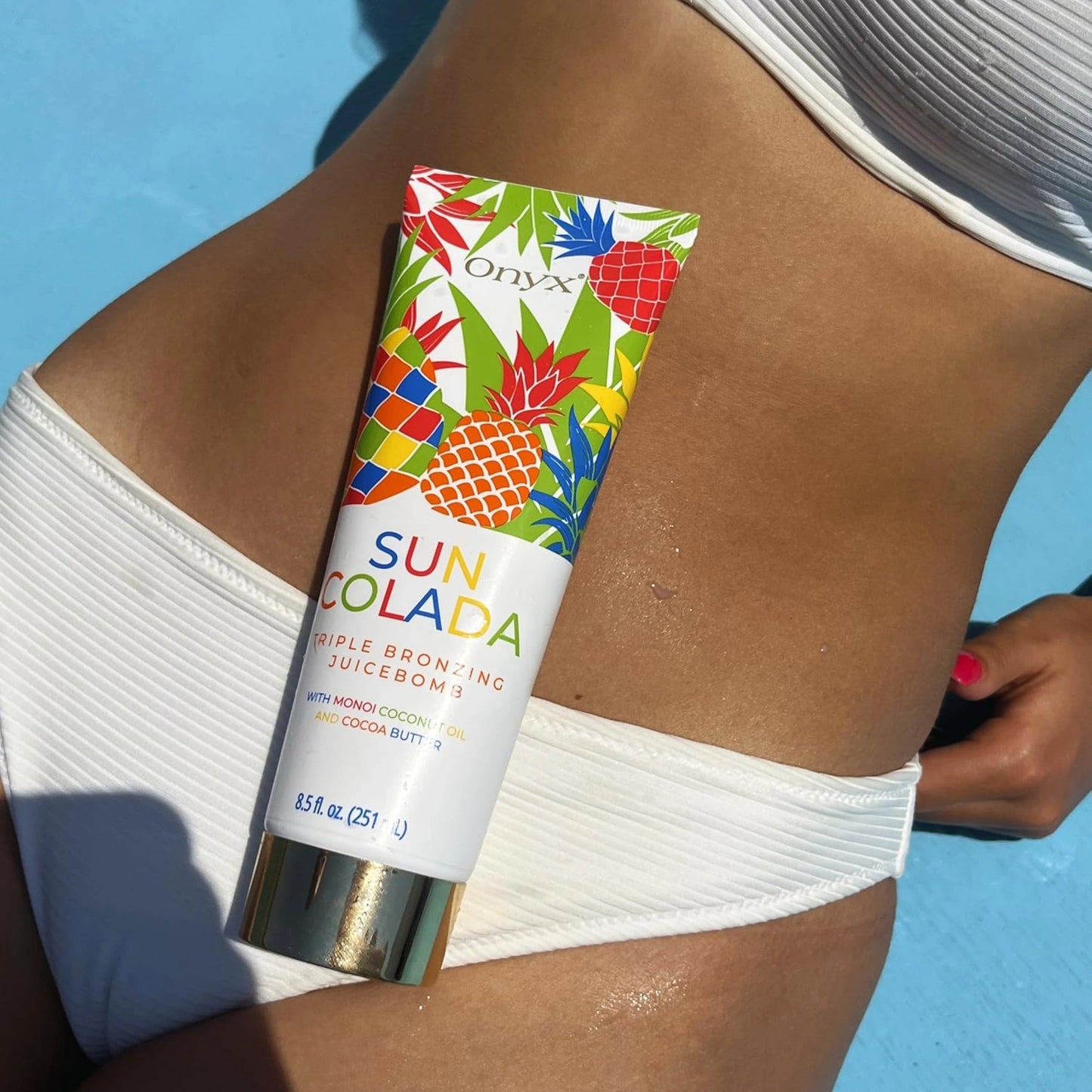 Onyx SunColada tanning lotion on tanned skin, designed for deep bronzing and hydration.
