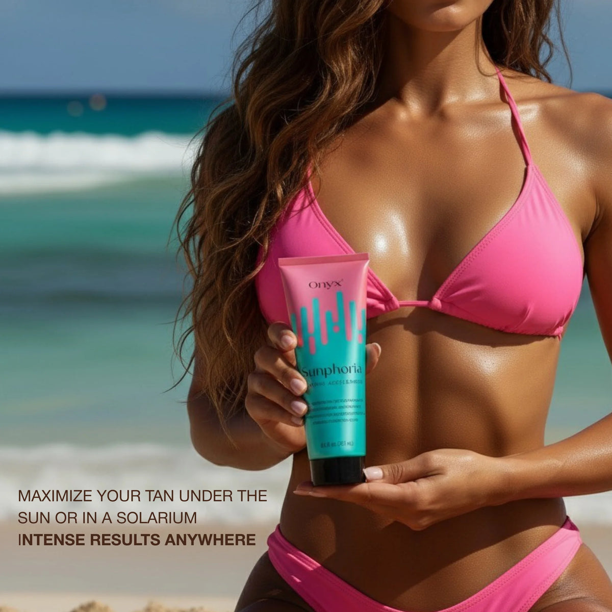 Woman standing on beach holding Onyx Sunphoria tanning accelerator lotion with ocean waves in background