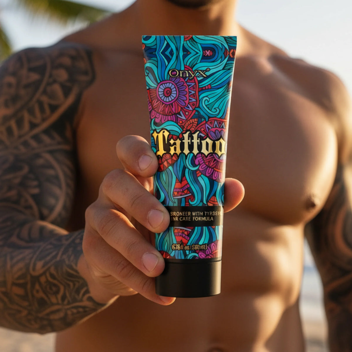 Tattooed man holding Onyx Tattoo tanning lotion on the beach