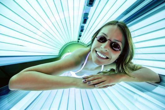 woman in protective glasses in a tanning bed - tanning tips for beginners