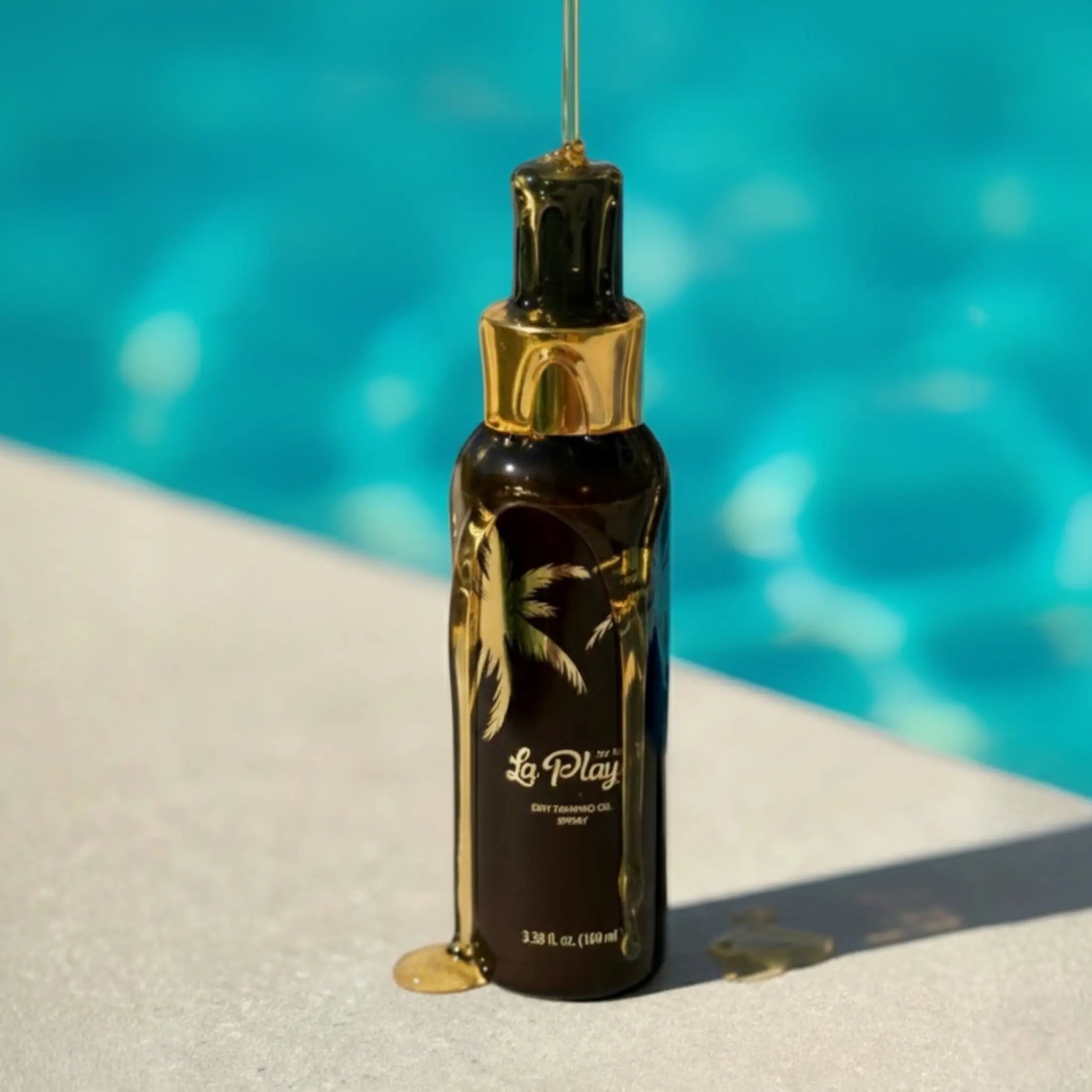 La Playa tanning oil bottle with dripping oil against pool background