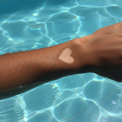 Heart-shaped tan line on skin showing contrast after sun tanning