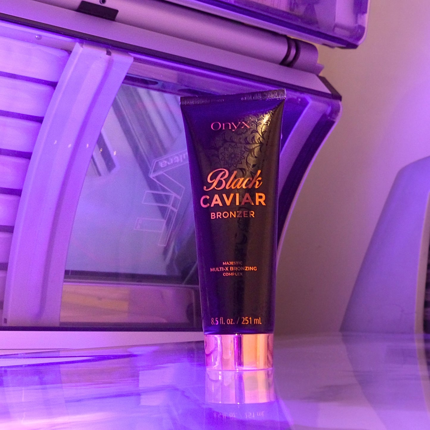 Onyx Black Caviar Bronzing Accelerator displayed with a mirror reflection, emphasizing its premium look and high-end tanning ingredients.