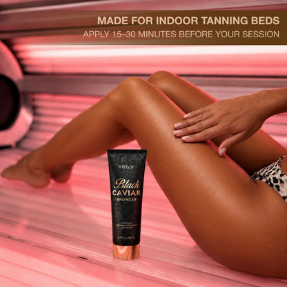 Onyx Black Caviar tanning bronzer displayed beside tanned legs in an indoor tanning bed
