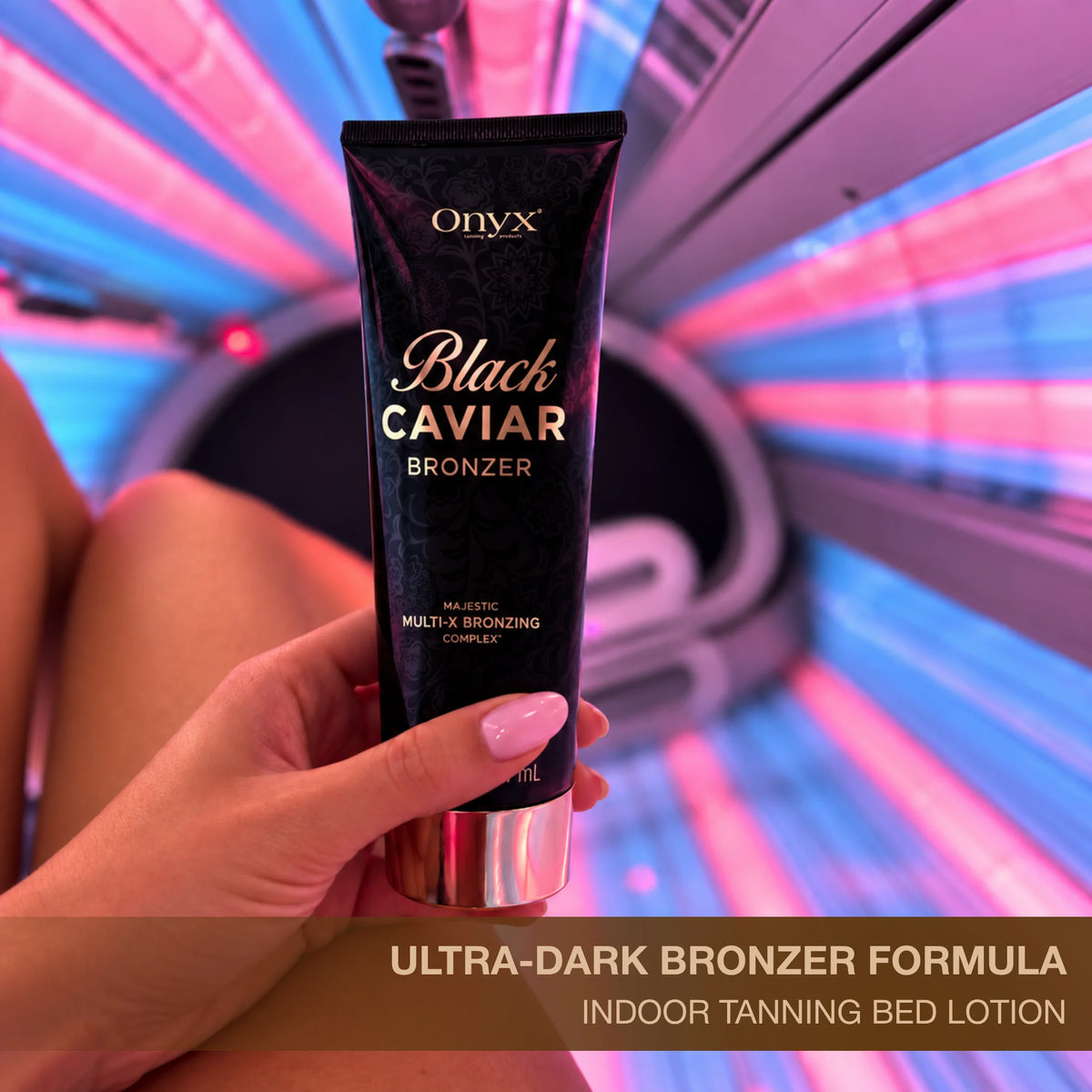 Onyx Black Caviar tanning bronzer held in front of an indoor tanning bed