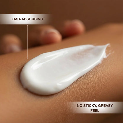 Close-up of white tanning lotion spread across the skin to show its smooth, lightweight texture.
