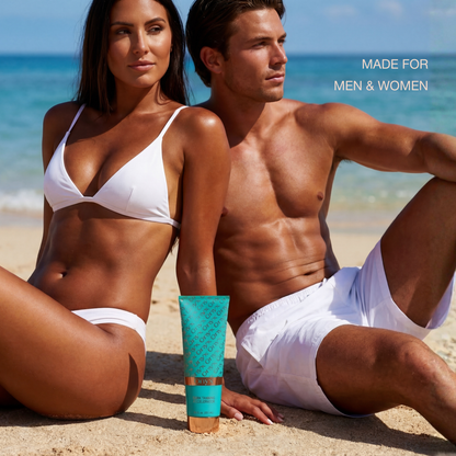 Tanned man and woman sitting on a beach in white swimwear with a tube of Onyx Dark Tanning Accelerator placed between them.