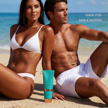 Tanned man and woman sitting on a beach in white swimwear with a tube of Onyx Dark Tanning Accelerator placed between them.