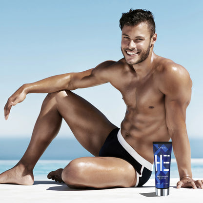 Sun-kissed man on the beach with Onyx HE Bronzing Intensifier – best tanning lotion for men’s skin.