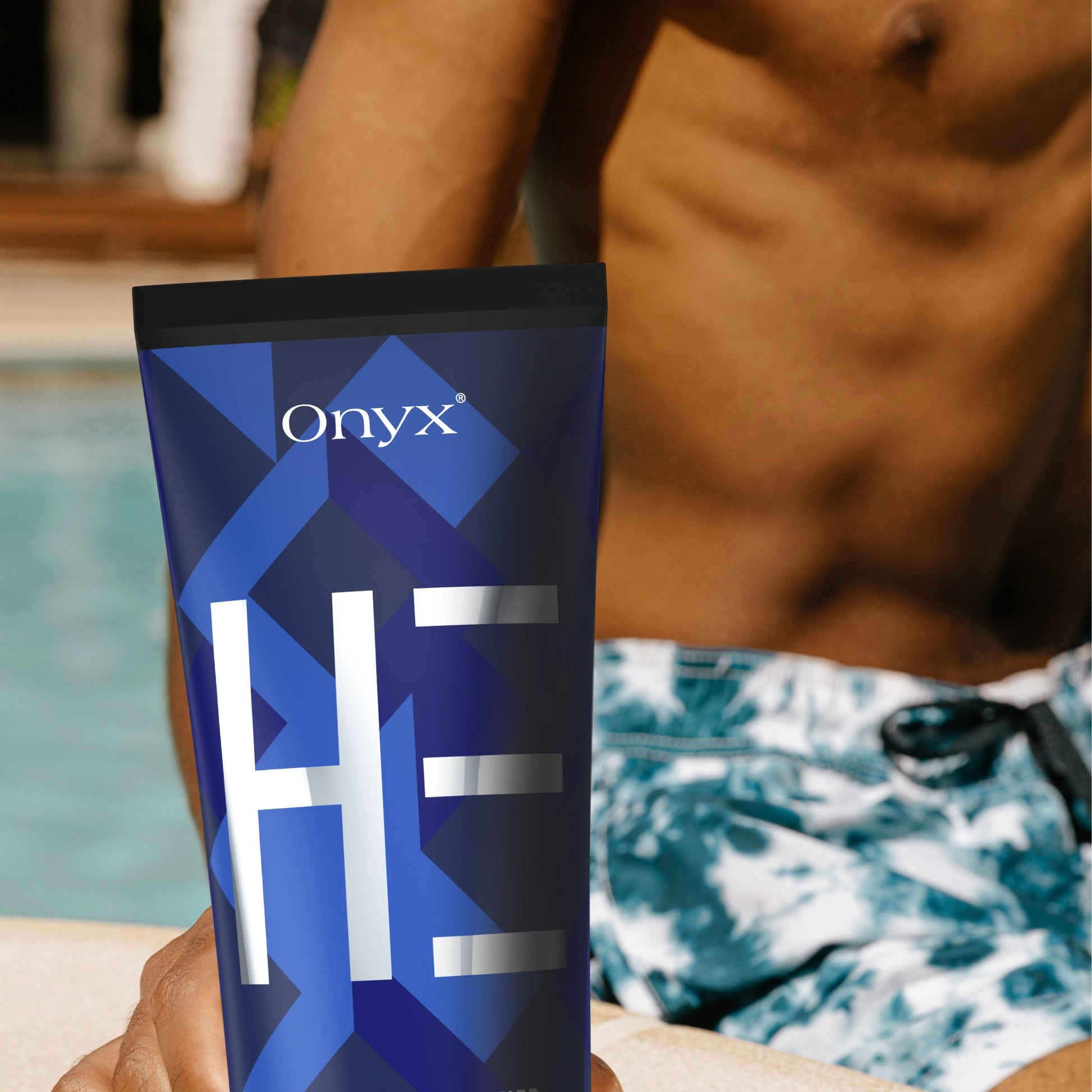 Onyx HE Men’s Tanning Lotion next to a pool – fast-absorbing bronzer for sun-kissed skin.