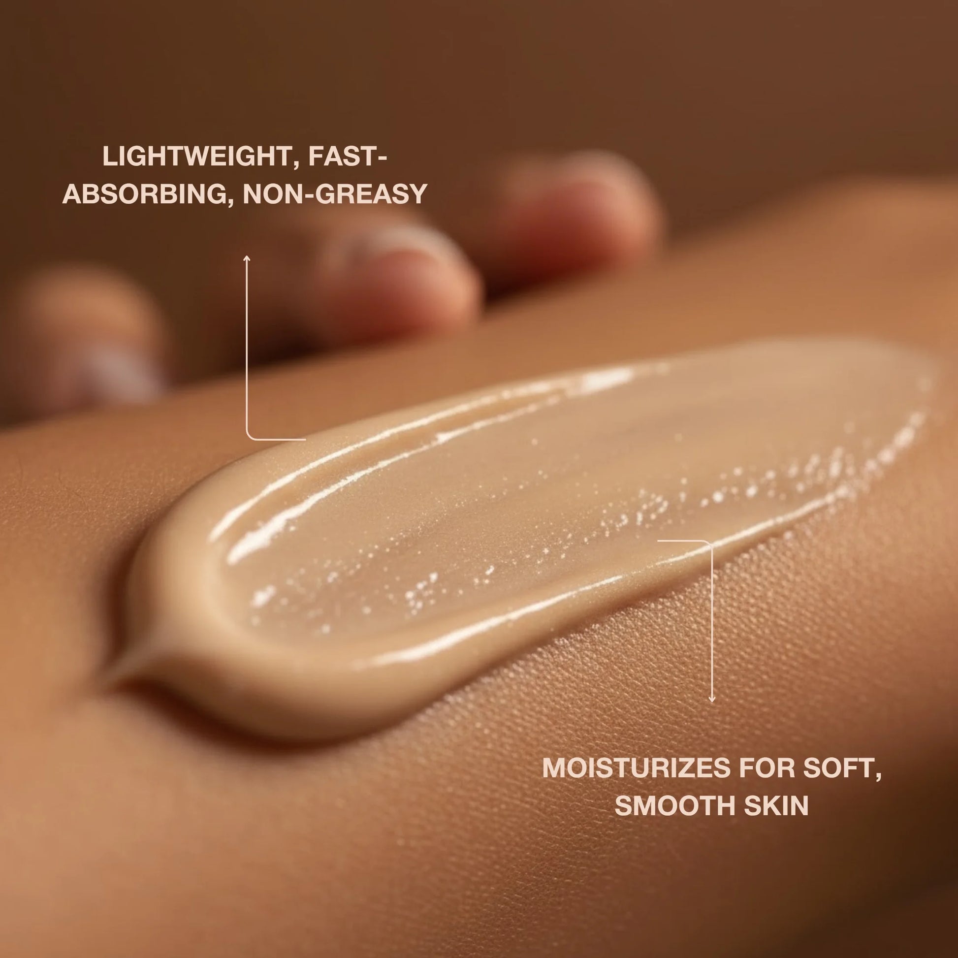 Close-up of creamy tanning lotion spread on skin, highlighting moisturizing texture and smooth finish.