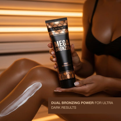 Close-up of Mega Bronzer lotion applied on leg, smooth creamy texture highlighted under warm tanning light.