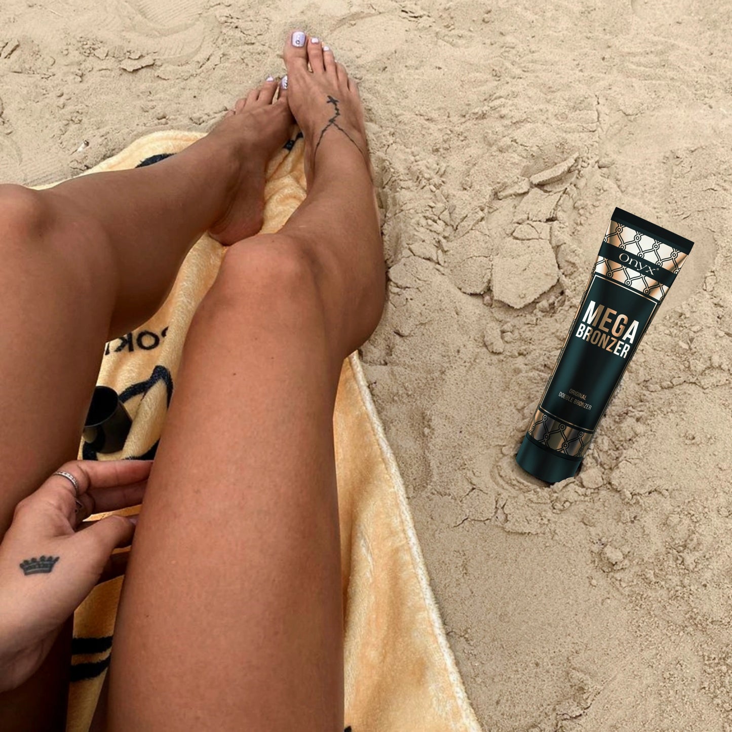 Tanned legs on the beach with Onyx Mega Bronzer Tanning Lotion – Outdoor tanning bronzer with melanin booster.