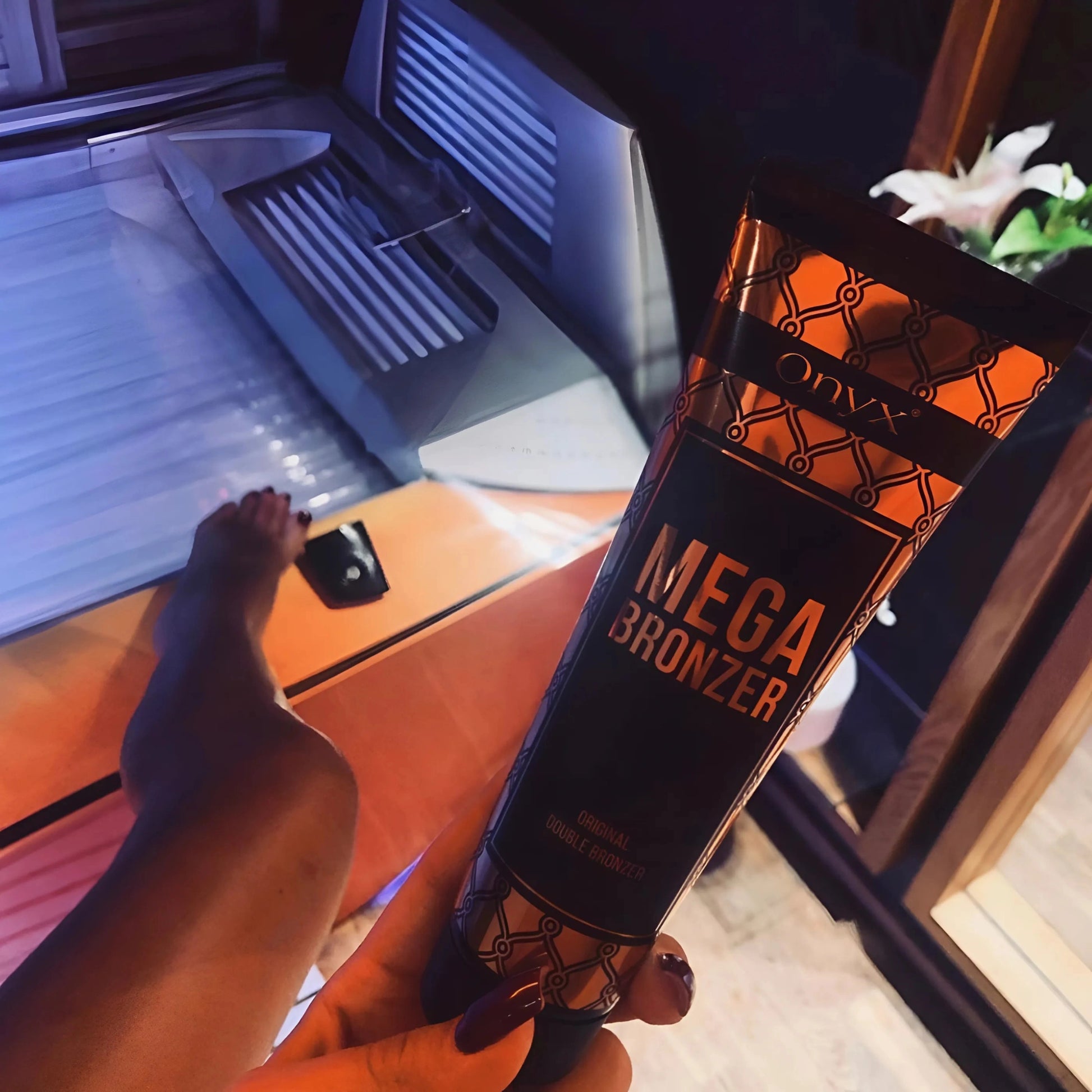 Onyx Mega Bronzer Tanning Lotion near a UV tanning bed – Perfect for sunbeds, sunless, and outdoor tanning sessions.