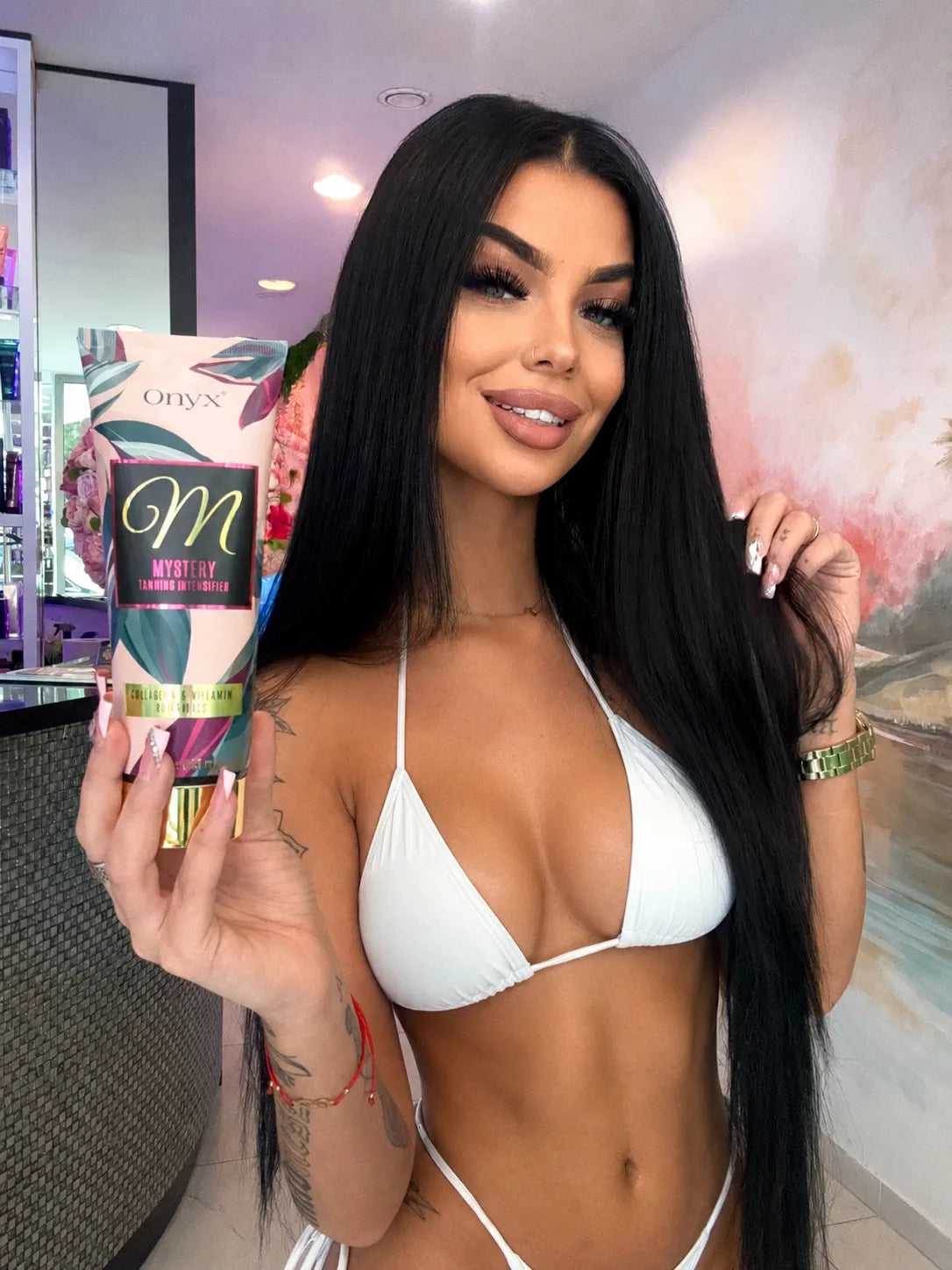 Woman in a white bikini holding Onyx Mystery 