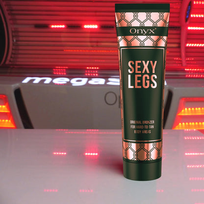 Onyx Sexy Legs tanning lotion standing on a red-lit tanning bed, formulated for maximum bronzing results in sunbeds.