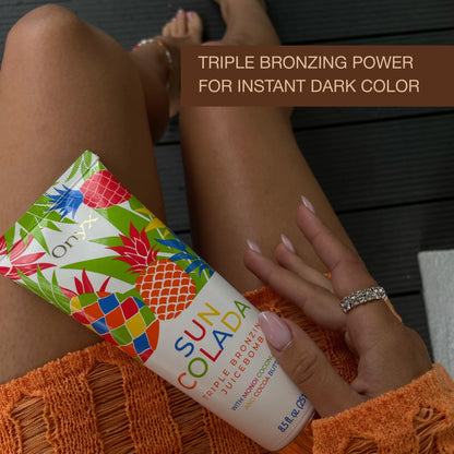 Onyx Suncolada Triple Bronzing Juicebomb tanning lotion on tanned legs with triple bronzing power for instant dark color text
