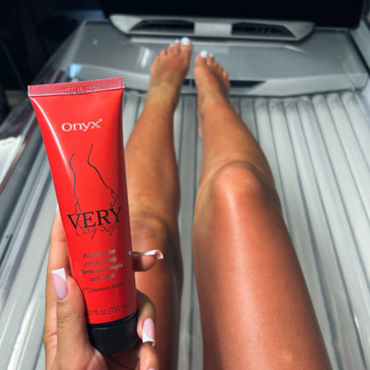 A model in a tanning bed using Onyx Very Sexy Legs Tingle Bronzer to enhance UV tanning results.
