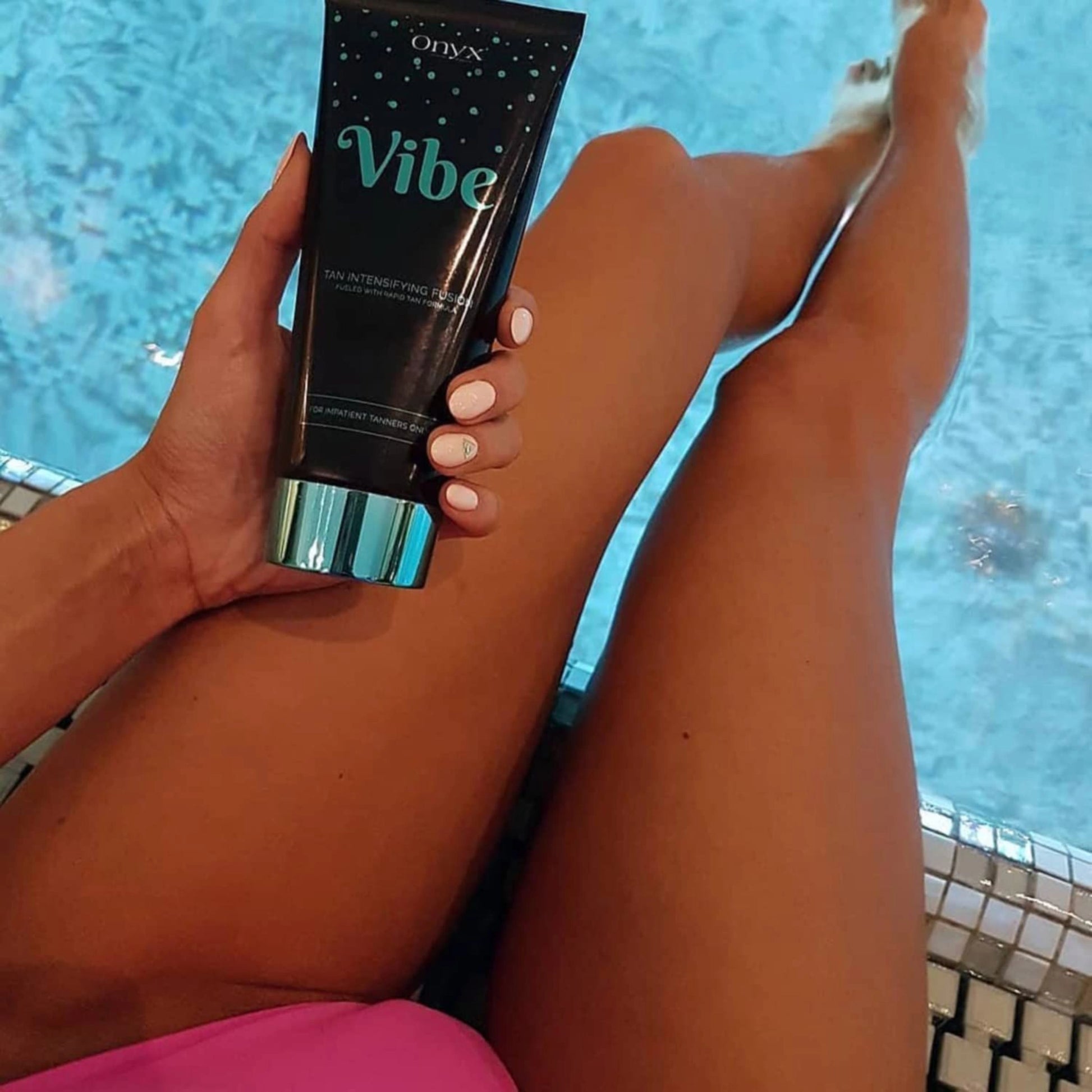 Onyx Vibe Tanning Accelerator next to a pool, enhancing a deep, glowing tan.